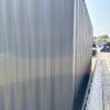 20ft Used Shipping Container – Matte Black w/ 12’ Side Roll-Up Door